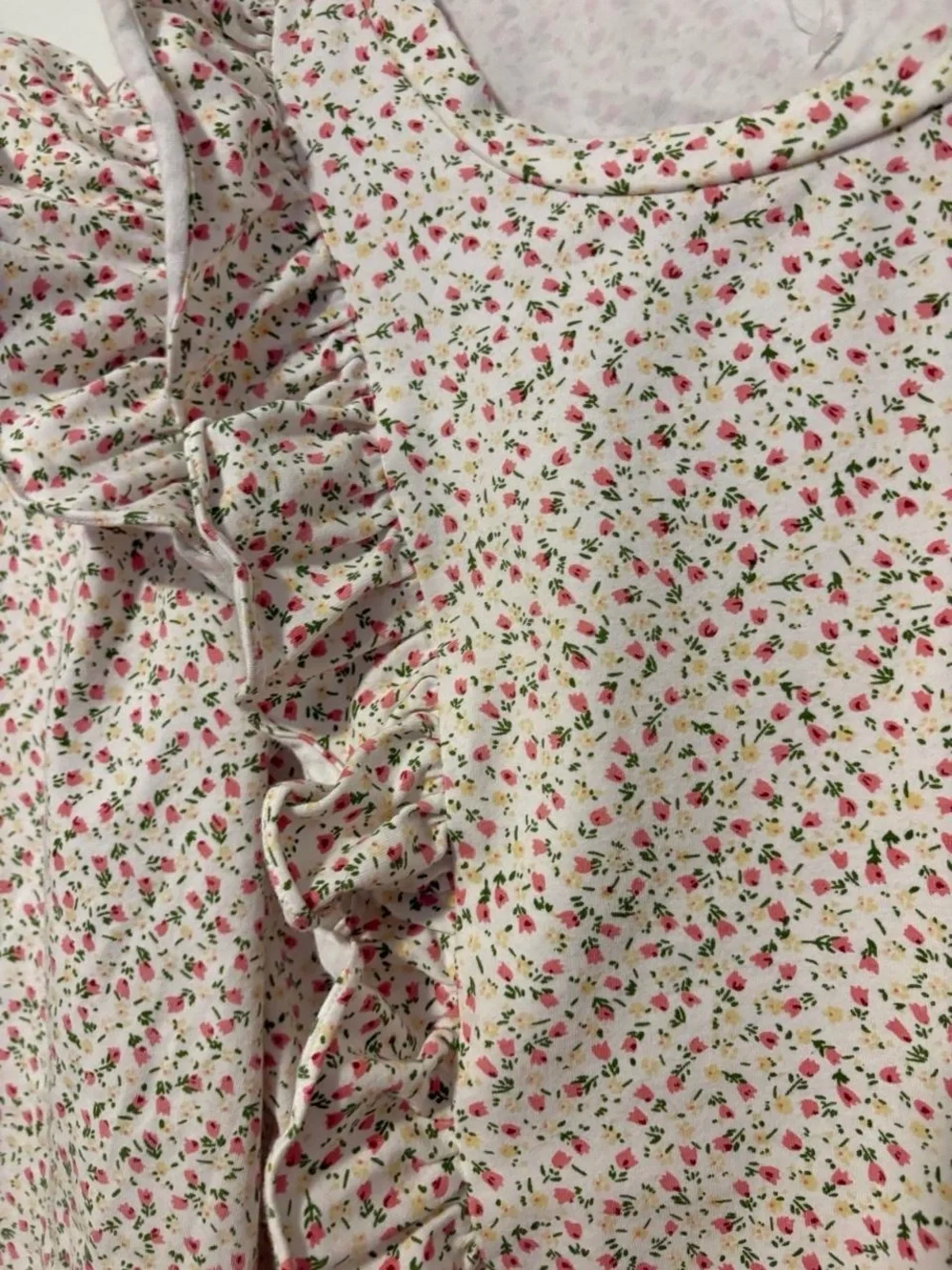 Anthropologie white cotton blouse with small pink ditzy floral print and ruffles